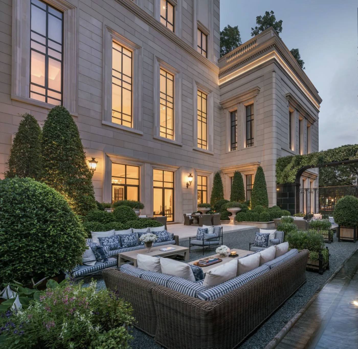 98 Wireless garden courtyard at dusk: limestone facade, landscaped topiary garden and outdoor lounge terrace, Wireless Road, Bangkok