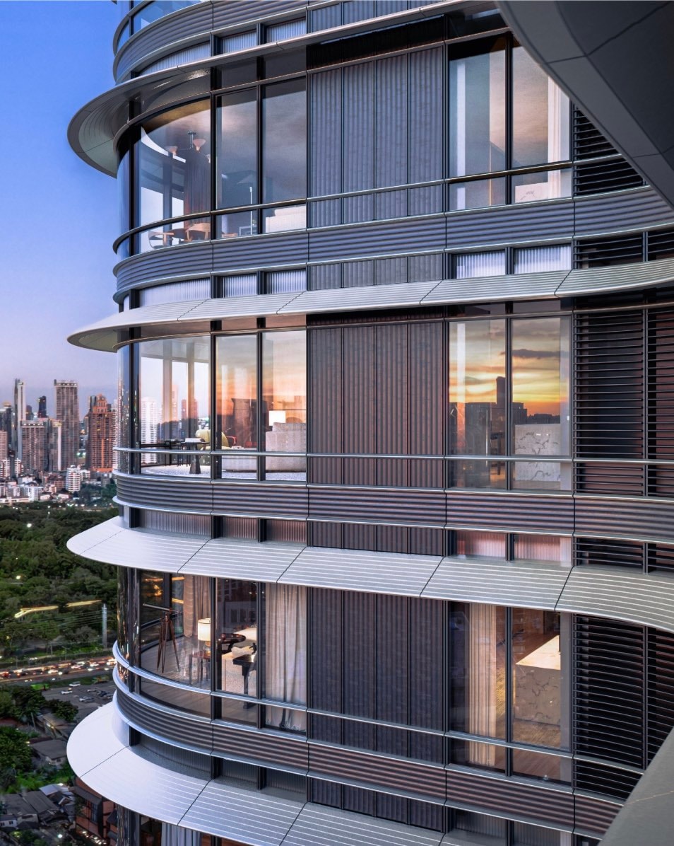 The curved glass facade and balconies of the Upper House development on Wireless Road at dusk, home to The Wireless Residences by Upper House